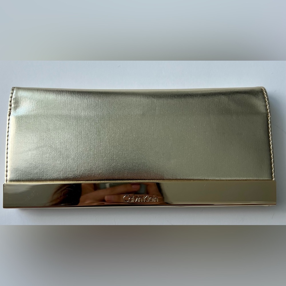 Gently used Calvin Klein Gold Clutch Gold Wallet, with mirror inside.
